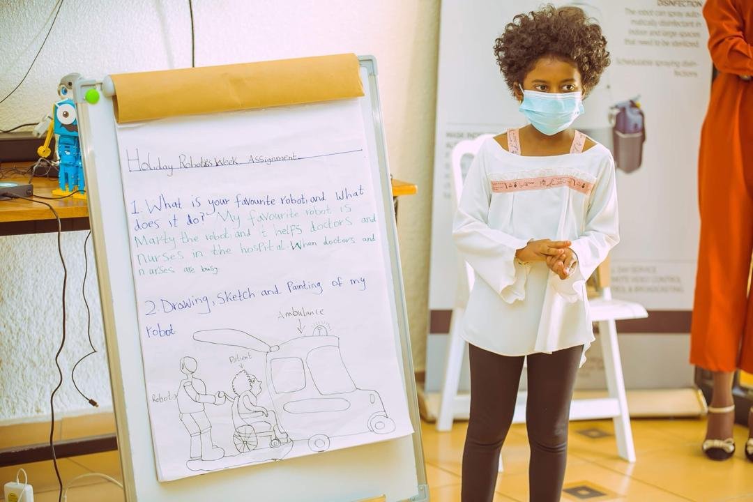 Young Jacky presenting a drawing of a healthcare robot concept